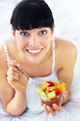 Image showing Fruits salad, happiness and bedroom portrait of woman with natural organic meal, snack or morning breakfast for healthy lifestyle. Home apartment bed, face and nutritionist smile for vegan food mix