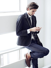 Image showing Fashion, phone and young man networking on social media, mobile app or the internet with formal outfit. Business, technology and male person scroll on a cellphone with classy, cool and elegant style.