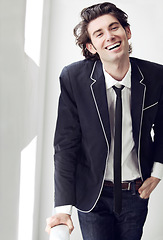 Image showing Happy, fashion and portrait of man by a wall with formal, stylish and classy outfit for confidence. Smile, suit and young male model with elegant, cool and trendy style by white background space.