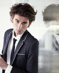 Image showing Fashion, formal and portrait of man in a studio with blazer, classy and elegant outfit for confidence. Handsome, suit and young male model with trendy and cool style with reflection in glass