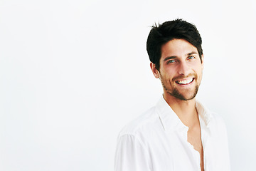 Image showing Happy young man, portrait smile and mockup with shirt for fashion or style against a studio background. Face of attractive or handsome male person or casual model posing with positive mindset
