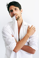 Image showing Portrait, fashion and man biting collar in studio isolated on a white background. Face, style and confidence of serious model, handsome and attractive person in trendy clothes, body or cool in Spain