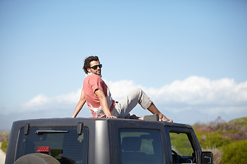 Image showing Road trip, man and roof of car for view, scenery, nature and fresh air on adventure or vacation in Africa. Person, tourist or traveler on rooftop with sunglasses and sky mockup for peace or journey