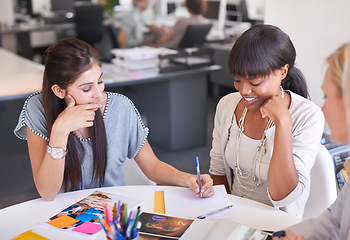 Image showing Business people, teamwork and writing in meeting for magazine, graphic design and project brainstorming or ideas. Group of young women or designer for creative notes, planning or agency collaboration