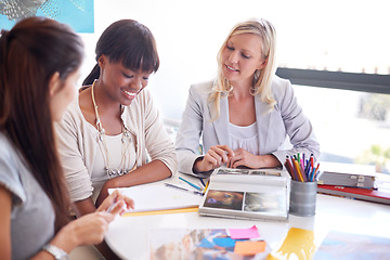 Image showing Business women, teamwork and meeting for magazine planning, collaboration or photograph and clients ideas. Designer group, manager and people with print, book catalog or portfolio at marketing agency