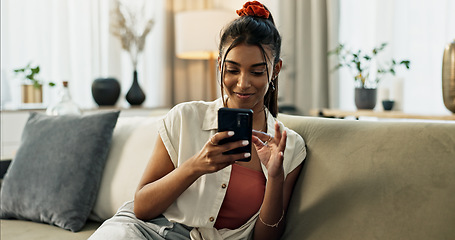 Image showing Woman, typing and scroll on cellphone, social media post and update subscription app on sofa at home. Happy indian girl, smartphone and download mobile games, reading notification and chat to contact
