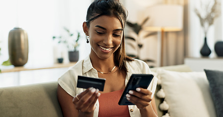 Image showing Woman, credit card and phone on sofa, smile or reading with cybersecurity, fintech app or bank info in home. Girl, smartphone and payment for password, budget or online shopping on e commerce website