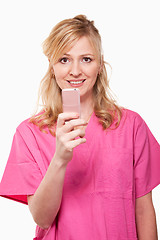 Image showing Nurse with pink cell phone