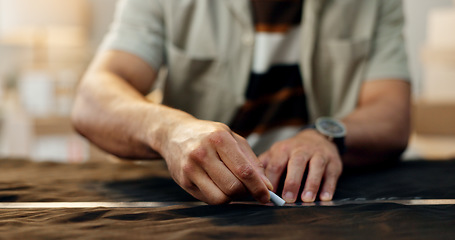 Image showing Closeup, hands and a tailor with clothes for measure, fitting or a design on fashion. Workshop, chalk line and designer, stylist or seamstress with manufacturing or production and creative on fabric