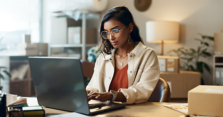 Image showing Ecommerce, woman and typing on laptop in office for research, feedback and supply chain for business. Indian, person or planning on pc for logistics, stock administration or package distribution data