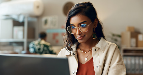 Image showing Woman, business and reading on laptop at work for research, feedback and supply chain for business. Indian, person and planning on pc for logistics, stock administration or package distribution data