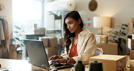 Image showing Designer, woman and typing email on laptop in office for research, feedback and supply chain for business. Indian, person or planning on pc for logistics, stock administration or package distribution