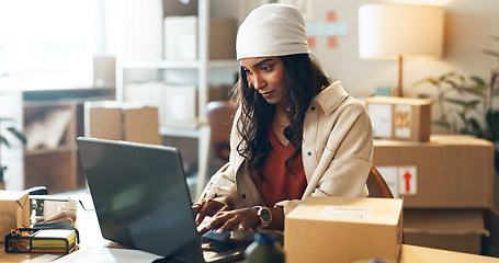 Image showing Woman, laptop and typing in small business logistics for order, ecommerce or design at boutique. Female person, tailor or fashion designer on computer for inventory, storage or inspection at store