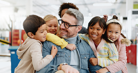 Image showing Hug, children and male teacher with happiness, smiling and excited for bonding, friends and education. Kids, embrace and memories for girls, boys and diversity in classroom, together and knowledge