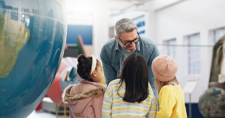 Image showing Science, geography and kids learning about the earth with a teacher at school for growth or development. World, globe or planet with a man teaching students about climate change or global warming