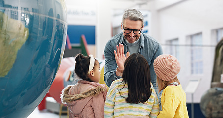 Image showing Science, high five and students learning about the earth with a teacher at school for child development. Planet, support or motivation with a man teaching kids about climate change or global warming