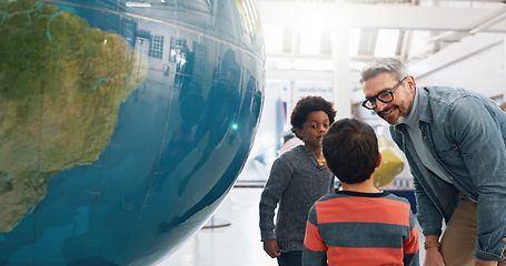 Image showing Science, geography and students learning about the earth with a teacher at school for growth or development. World, globe or planet with a man teaching kids about climate change or global warming