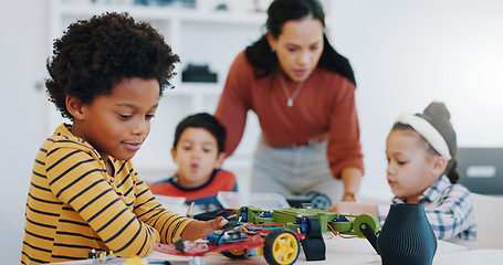 Image showing Electronics, boy and car robotics in classroom for learning, education or technology with car toys for innovation. School kids, learners and transportation knowledge in science class for research