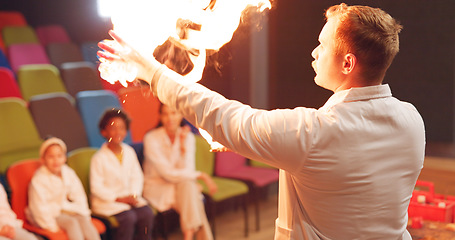 Image showing Science, students and fire experiment with teacher for development, innovation and knowledge in hall. Chemistry, children or flame for chemical research, learning and teaching at school or exhibition