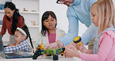 Image showing Technology, girls or robotics in classroom with teacher for learning, education or electronics with car toys for innovation. School kids, learners or transport knowledge in science class for research