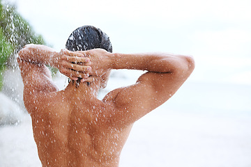 Image showing Shower, beach and man with water for cleaning, washing hair and grooming for healthy skin. Beauty, nature and back of person with splash for hygiene, wellness and skincare hydration and cleanse