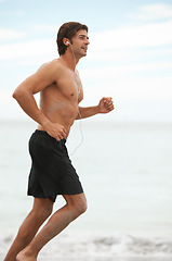 Image showing Man, music and running on beach exercise workout, cardio playlist or summer sport training. Male person, streaming listening and fitness at sea or headphones speed performance, healthy body or audio