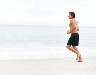 Image showing Man, music and running on beach cardio workout, exercise playlist or summer sport training. Male person, streaming listening and fitness at sea or headphones speed performance, healthy body or audio