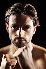 Image showing Portrait, man and fist of serious boxer in studio isolated on a black background. Face, boxing and confidence of topless athlete ready for fight, exercise training or workout, sport or combat fitness