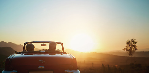 Image showing Back, sunset and a senior couple on a road trip in a convertible car for travel, freedom or adventure together. Love, mockup or view of nature with an elderly man and woman in a vehicle for a drive