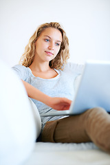 Image showing Sofa, remote work and woman typing on laptop in home, reading email or network on internet. Computer, freelance and girl in living room on social media, online or communication on technology to relax