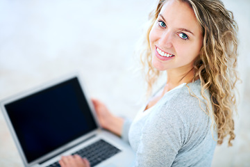 Image showing Laptop, portrait and happy woman in home, typing email and internet. Computer, face and smile of girl in living room on social media, website or online communication on tech to relax on mockup space