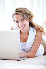 Image showing Laptop, portrait and happy woman in house on floor, typing email and remote work. Computer, smile and face of person on social media, website and online communication on digital technology to relax