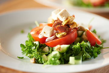 Image showing Background, salad and healthy plate of food for lunch, dinner and nutrition for detox, diet or eating in cafe. Closeup, vegan cuisine or dining in restaurant for meal of leafy greens, tomato and feta