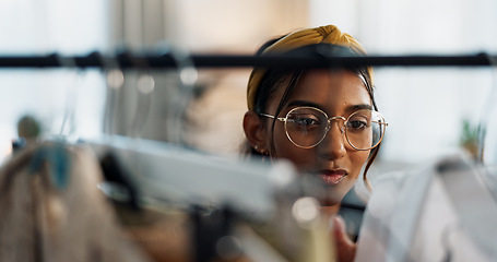 Image showing Shopping, fashion and woman at a mall for clothes, outfit or thrift store sale choice. Retail, decision or Indian lady customer check fabric quality, clothing rack or discount deal search at boutique