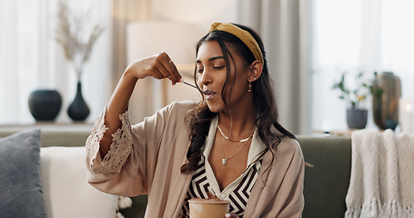 Image showing Woman, eating ice cream and home on couch, thinking or idea for dessert, sweets or relax in living room. Girl, gelato or frozen yogurt for snack, lounge sofa and house with memory, choice or decision