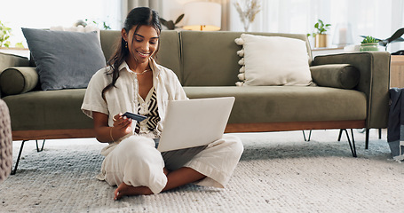 Image showing Woman, laptop and credit card for home online shopping, fintech payment and e commerce on living room floor. Young person typing on computer for internet banking, web subscription or loan on carpet