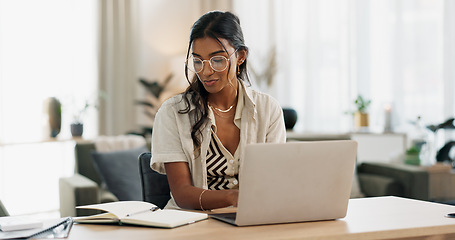 Image showing Woman with laptop, notes and typing in home office planning freelance research project at desk. Computer, internet search and thinking, girl with glasses writing online article for remote work job.