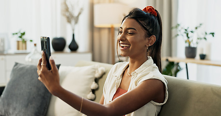 Image showing Woman, selfie and smile on sofa in home living room with web blog, post or update on mobile app. Influencer girl, live streaming or video call with memory, profile picture and social media in house