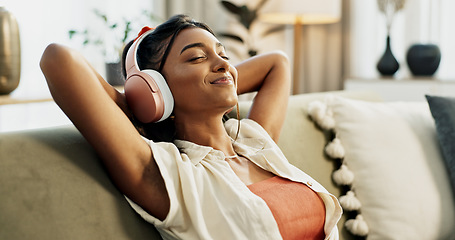 Image showing Woman, headphones and relax with music, sofa and peace with sound, smile or hearing in home living room. Girl, listening and audio streaming subscription on lounge couch, happy or radio show in house