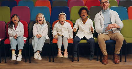 Image showing Wow, students and teacher at a science showcase, in the audience as a crowd of school children on an outing. Education, study and kids learning with a professor man in an assembly for a lecture