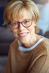 Image showing Portrait, glasses or happy mature woman in house living room to relax with freedom on sofa for resting break. Apartment, face or senior person with smile or wellness in retirement, lounge or home