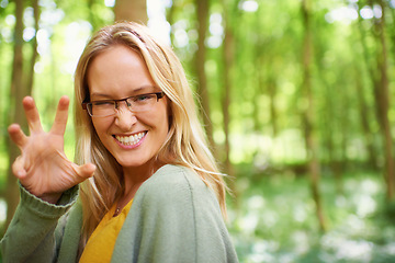 Image showing Woman, glasses or nature with hand for playful, growl by countryside with portrait in trendy fashion. Sweden, person or happy face for eyewear in natural glow, outdoor fun or sunshine to joke in park