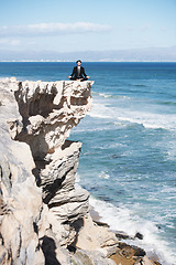 Image showing Business man, relax and meditation on rock, peace and spiritual wellness by ocean, sea and outdoors. Male person, breathing exercise and yoga for stress management, zen mindfulness on cliff in Hawaii