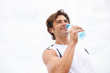 Image showing Man, smile and drinking water on break from workout, earphones and hearing music, podcast or song on run. Male athlete, thirsty and hydrated for exercise, cardio and fitness outdoor with mockup