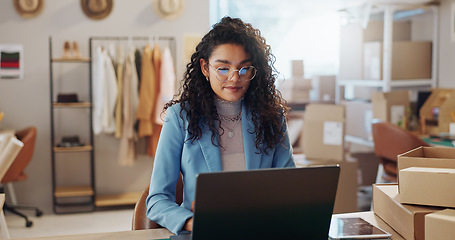 Image showing Woman, fashion and designer with laptop in logistics, research or small business management at boutique. Female person or entrepreneur with computer for inventory or storage check at retail store