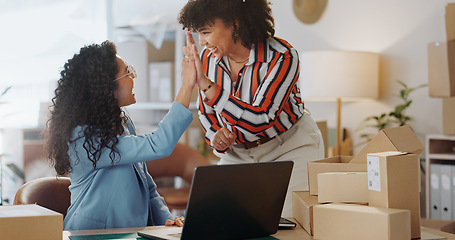 Image showing Happy woman, team and high five with laptop in logistics, small business success or fashion design at boutique. Female person touching hands in teamwork for achievement, sale or promo at retail store