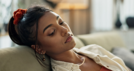 Image showing Depression, sad and young woman on sofa relaxing with an idea or memory in living room. Burnout, mental health and nervous Indian female person with stress chilling in the lounge of modern apartment.