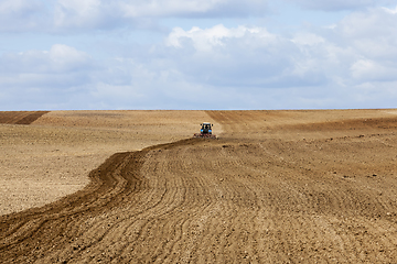 Image showing an old tractor plows the soil