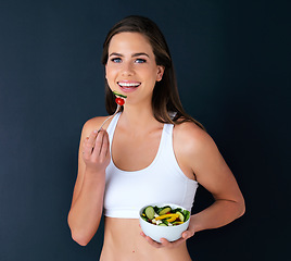 Image showing Happy woman, portrait and salad bowl for diet, lose weight or natural nutrition in fitness against a studio background. Female person or model smile with vegetables for food, healthy meal and fiber