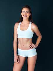 Image showing Happy woman, portrait and fitness to lose weight, health and wellness against a studio background. Active female person smile with hand on hip for body workout, exercise or training on mockup space